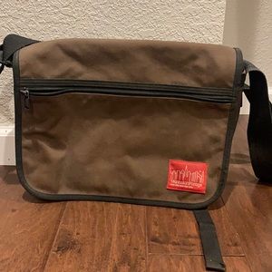 Manhattan Portage messenger bag. Brown with black trim. Incredibly durable bag.